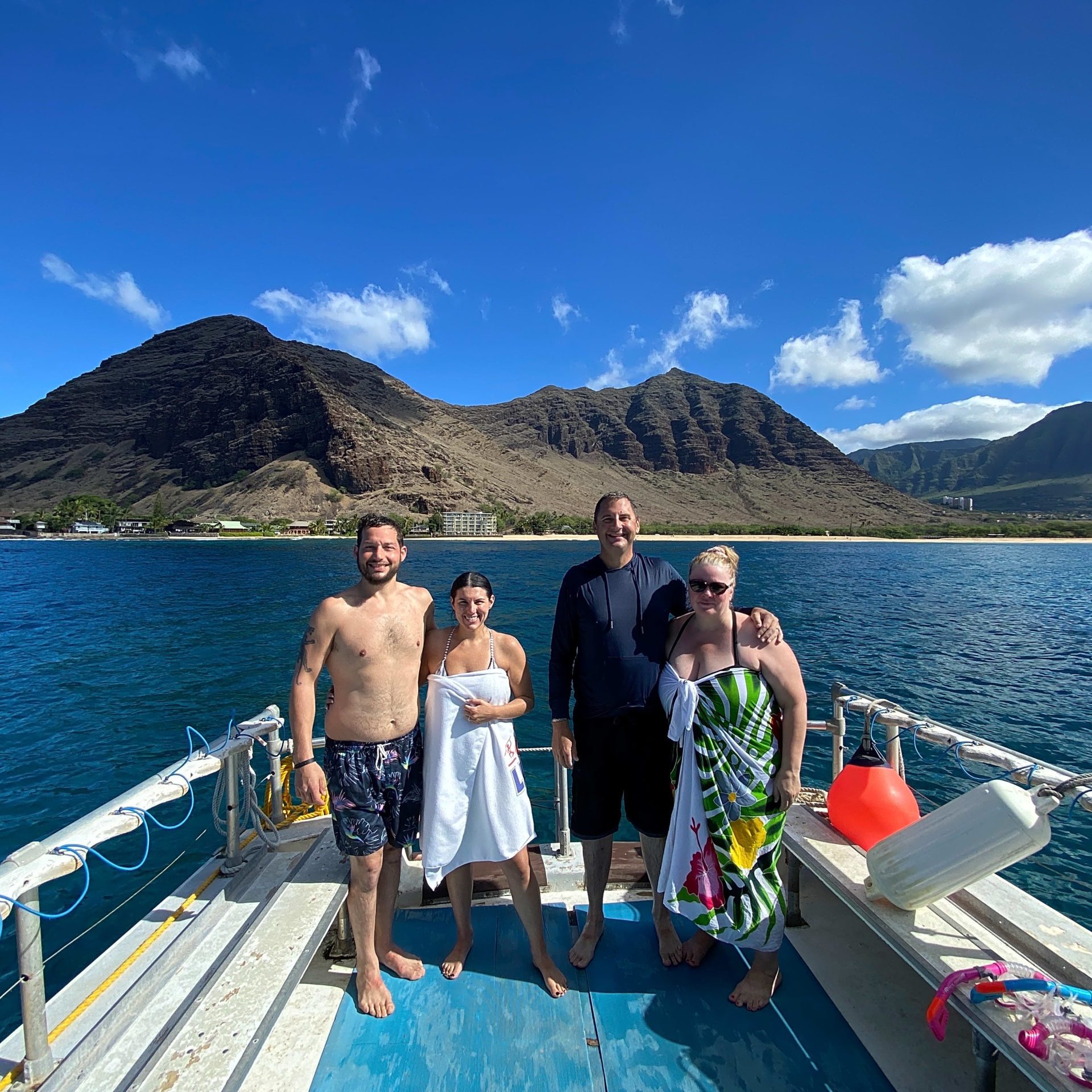 a group of people standing next to a body of water