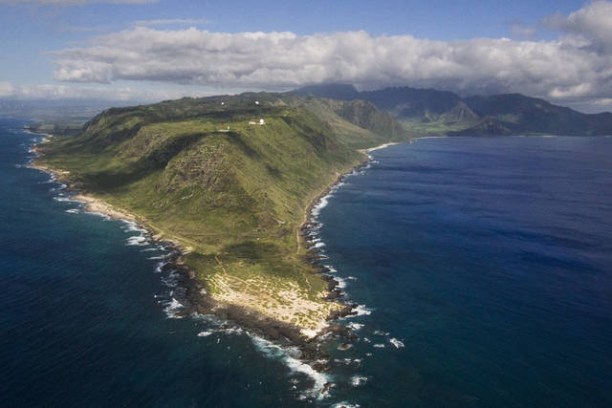 a body of water with a mountain in the background
