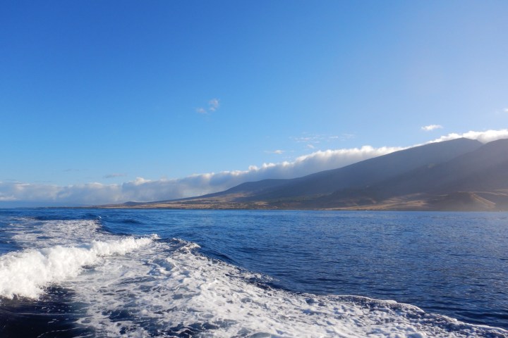 a body of water with a mountain in the background