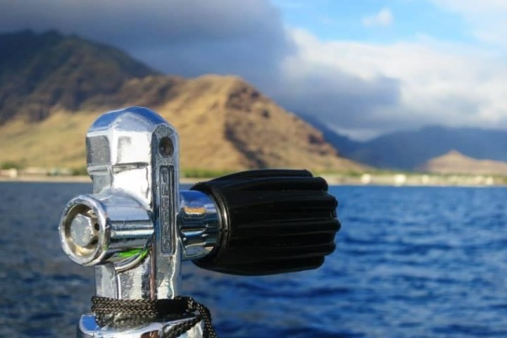 a body of water with a mountain in the background